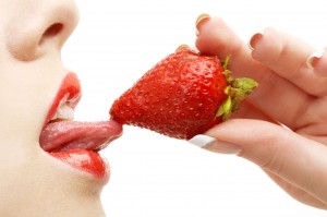 Lady Enjoying Strawberry: Delightful Moment